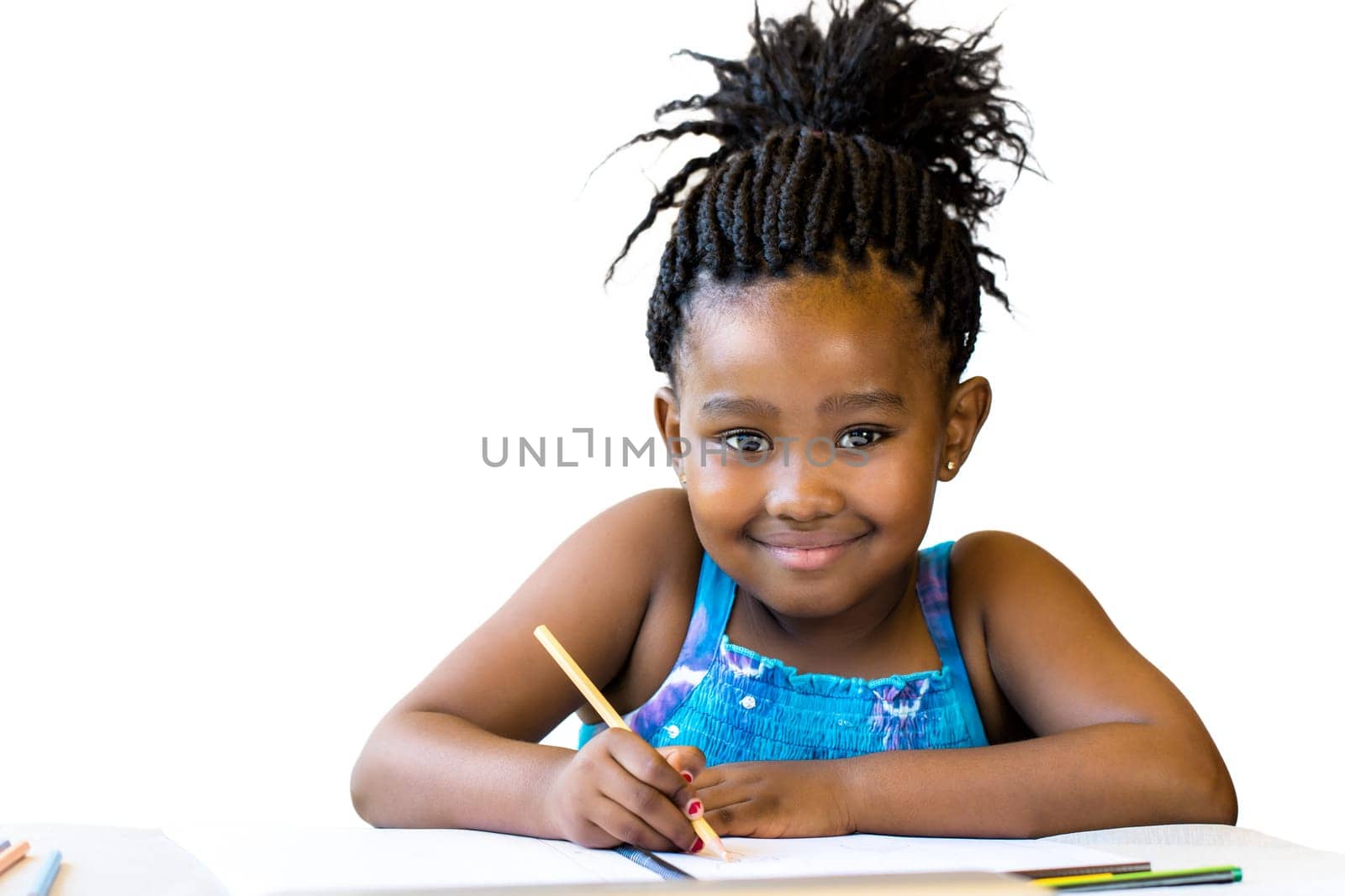Close up portrait of little african girl holding color pencil at desk.Isolated on white background.