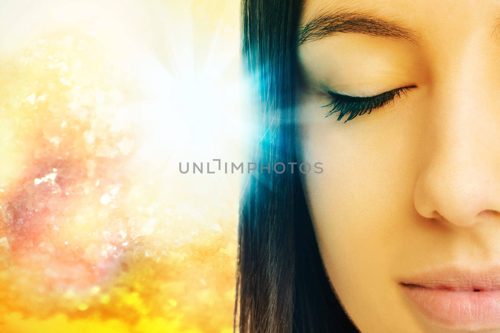 Macro close up of young woman meditating with eyes closed.Conceptual spiritual background with light beam.