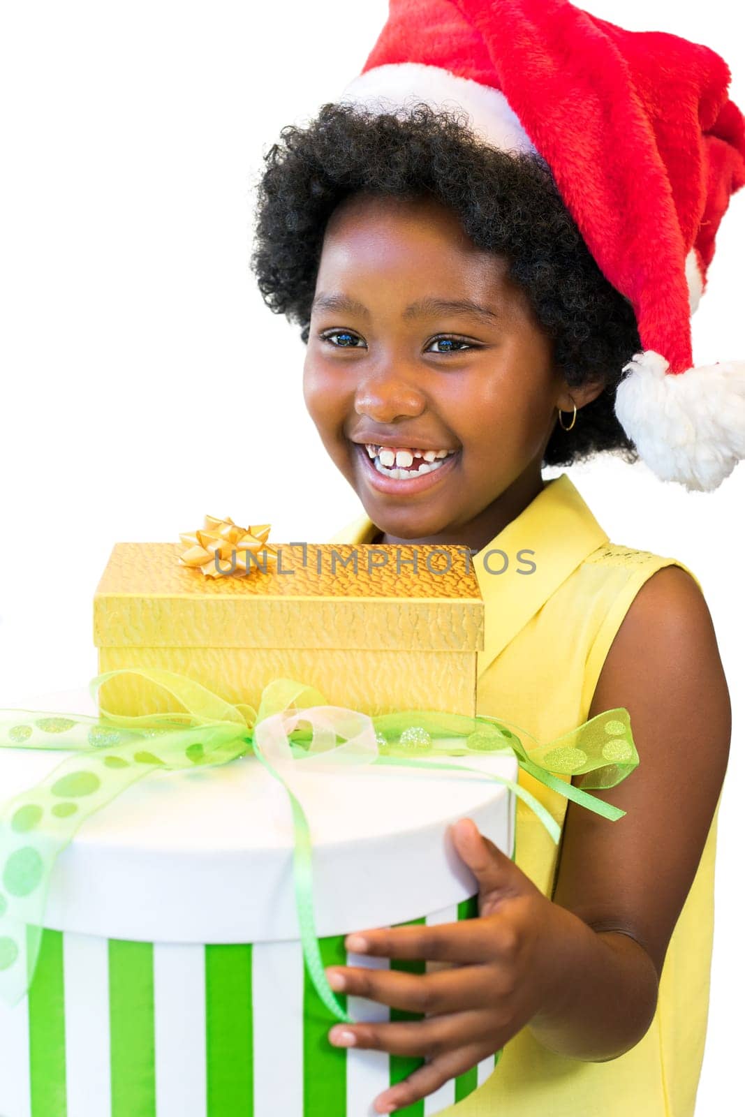 Close up portrait of laughing african girl holding christmas presents.Child wearing red hat isolated on white background.