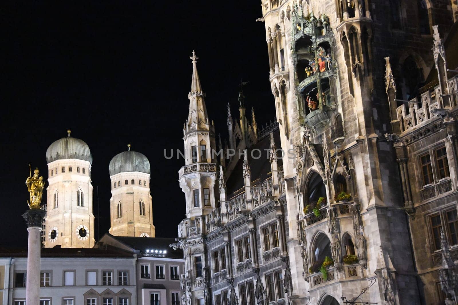 The new town hall with the Frauenkirche at Marienplatz and the Mariensäule in Munich,Bavaria,Germany and Europe. The historic buildings are landmarks of the state capital.