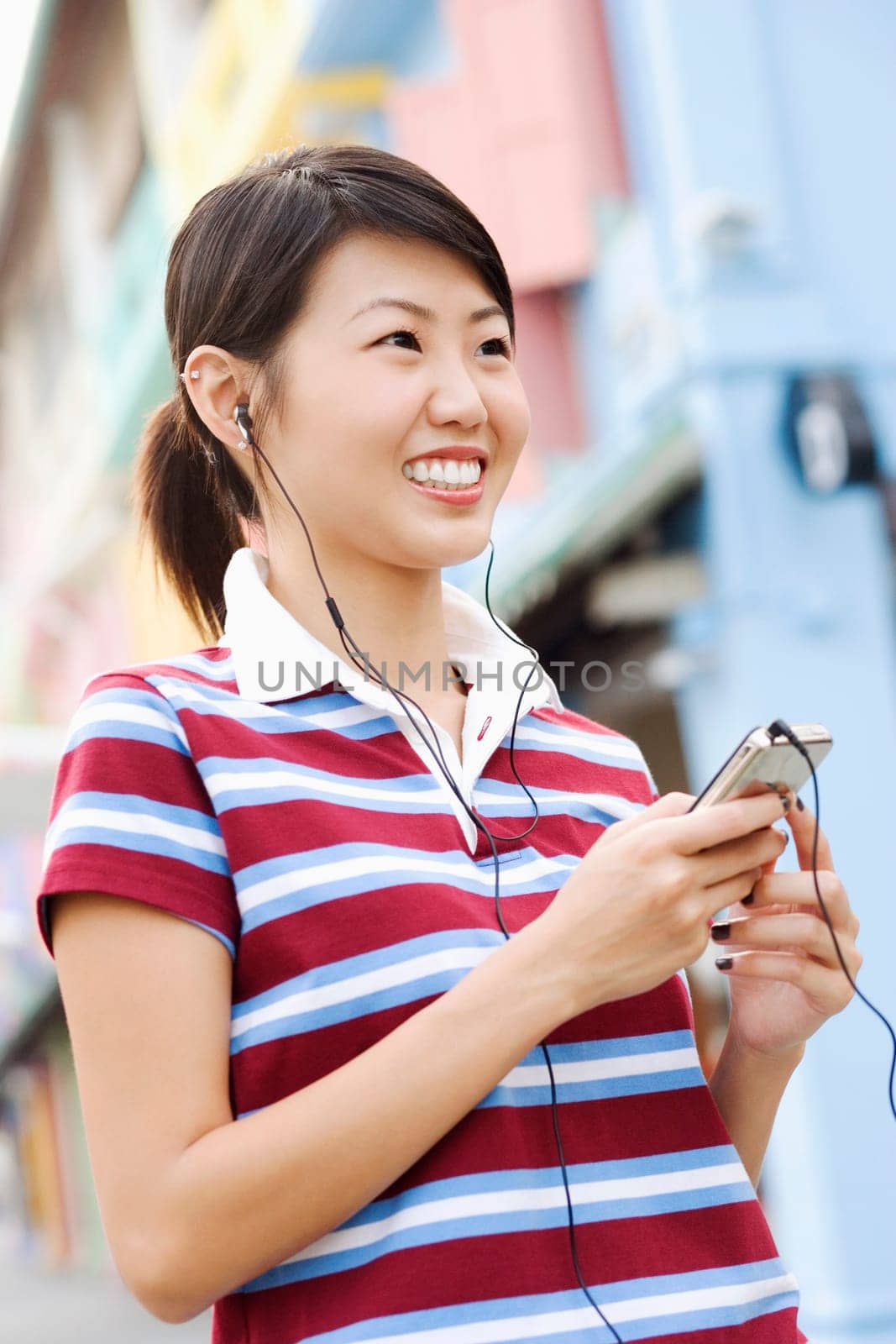 Close-up of a young woman listening to an MP3 player