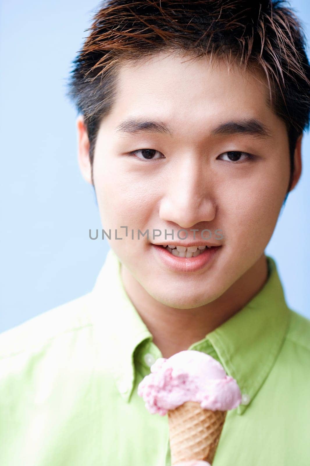 Portrait of a young man holding an ice-cream cone
