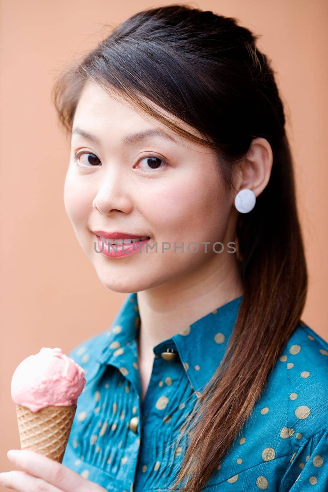 Portrait of a young woman holding an ice-cream cone