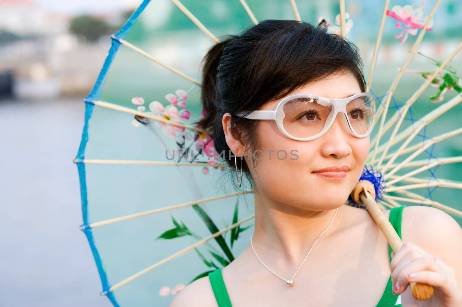 Close-up of a young woman holding a parasol