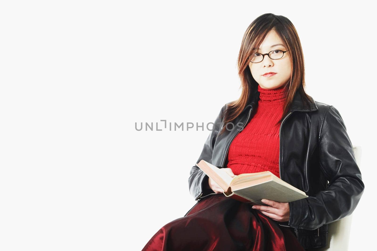 Portrait of a mid adult woman holding an open book