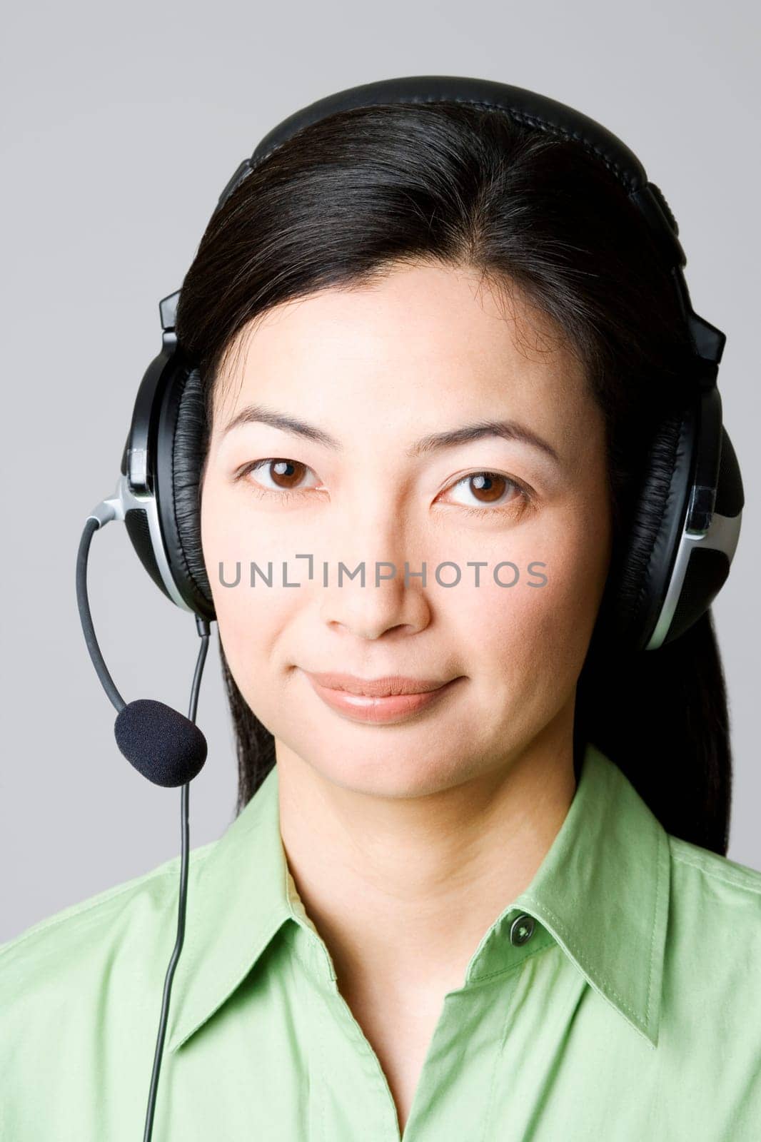 Portrait of a mid adult woman with a headset on her ear