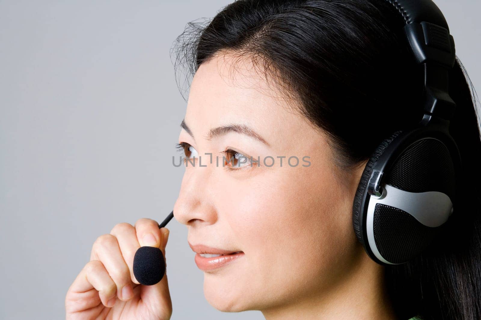 Side profile of a businesswoman using a headset