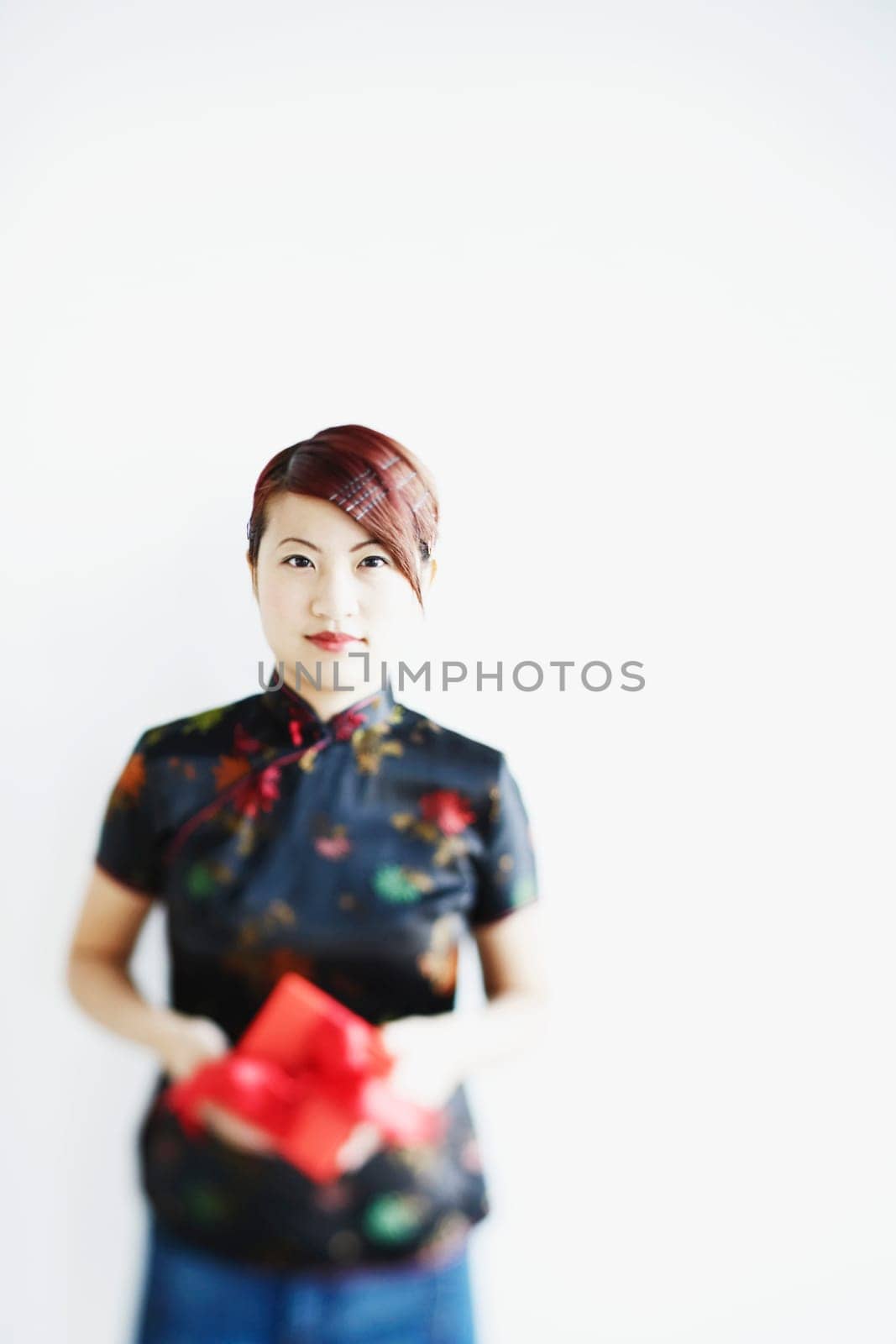 Portrait of a young woman holding a gift in her hands