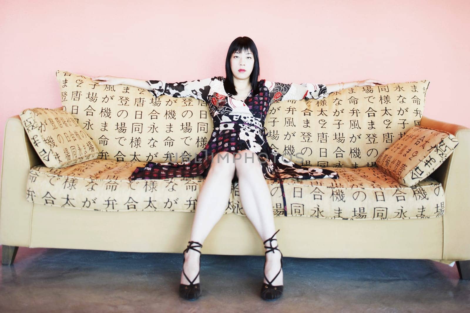 Portrait of a young woman sitting on a couch