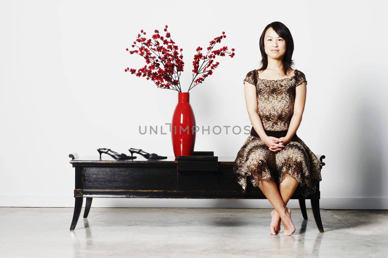 Portrait of a young woman sitting on a table