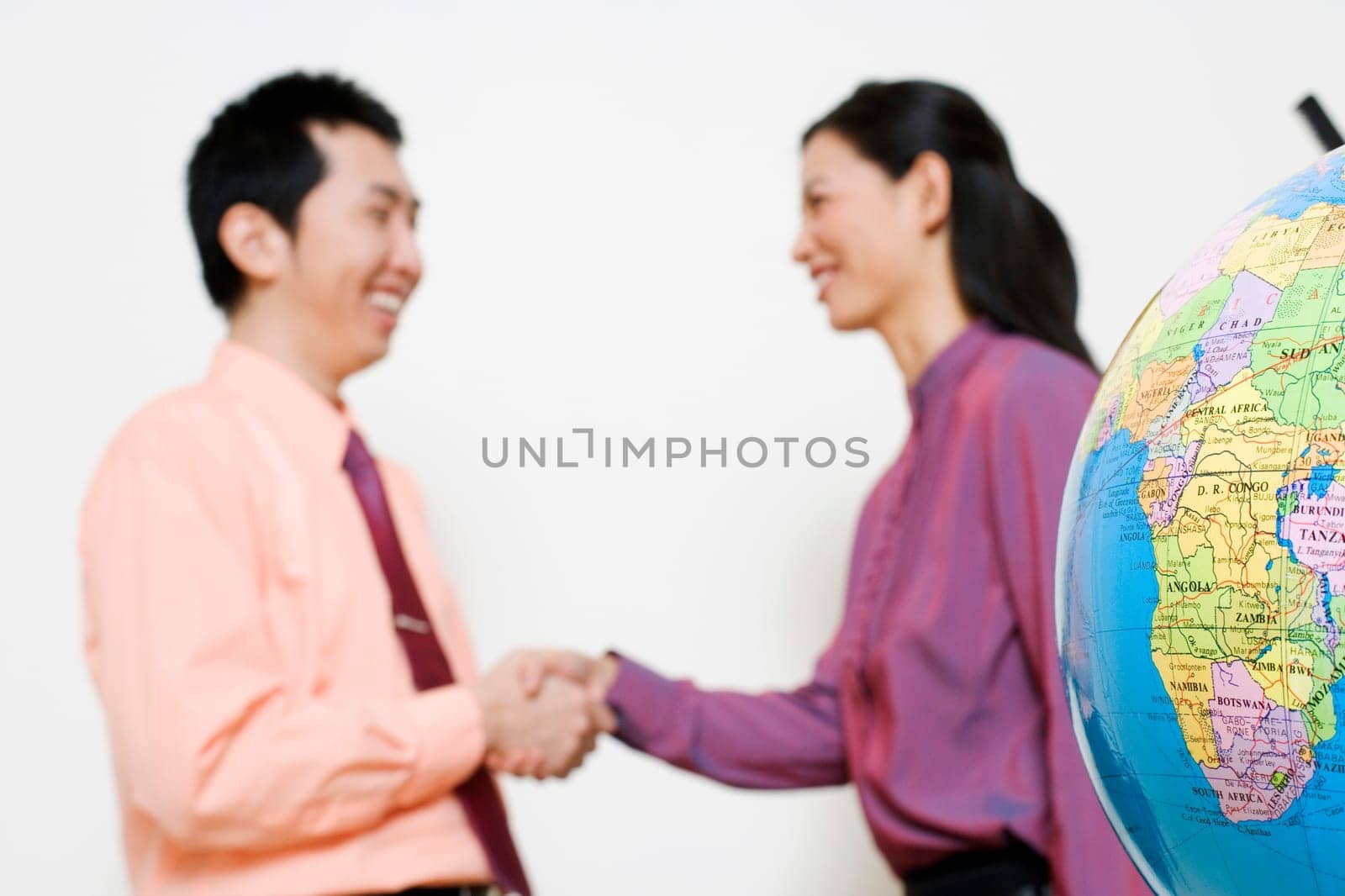 Businesswoman shaking hands with a businessman