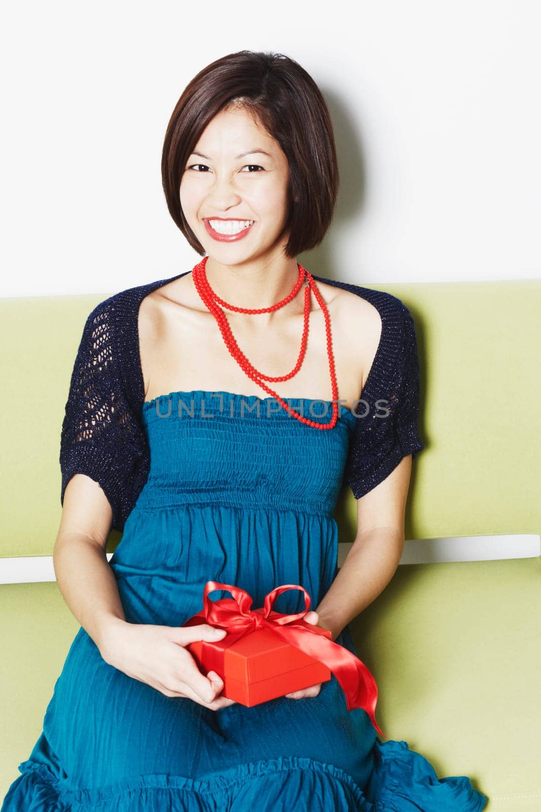 Portrait of a young woman holding a gift