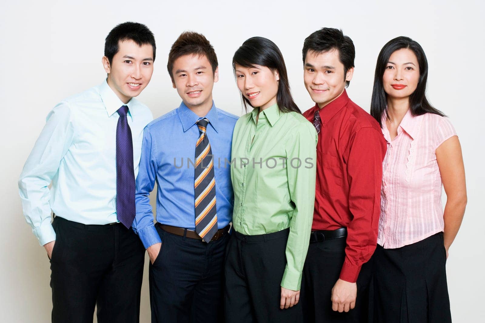 Portrait of five business executives standing together and smiling