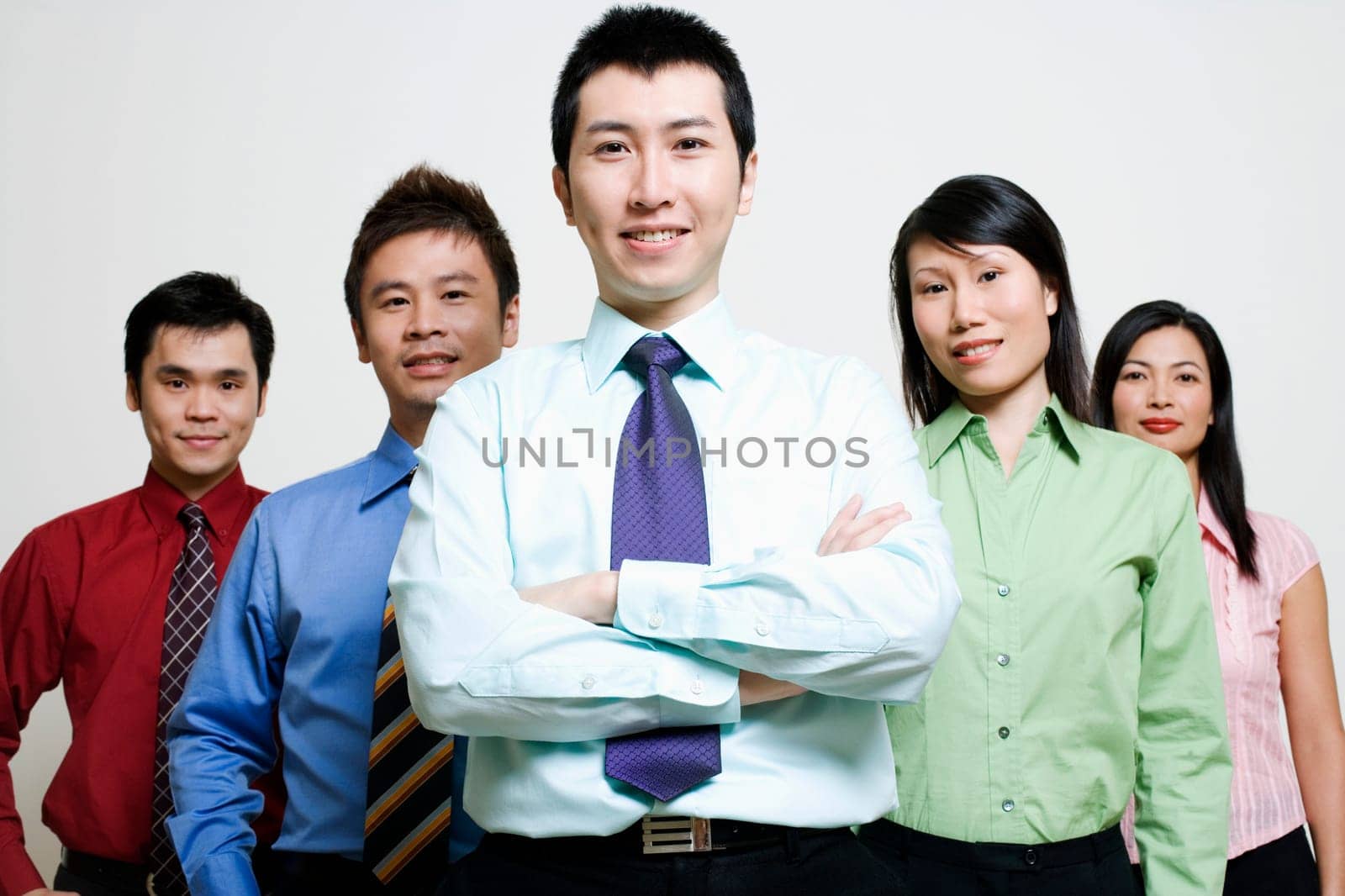 Portrait of five business executives standing together and smiling