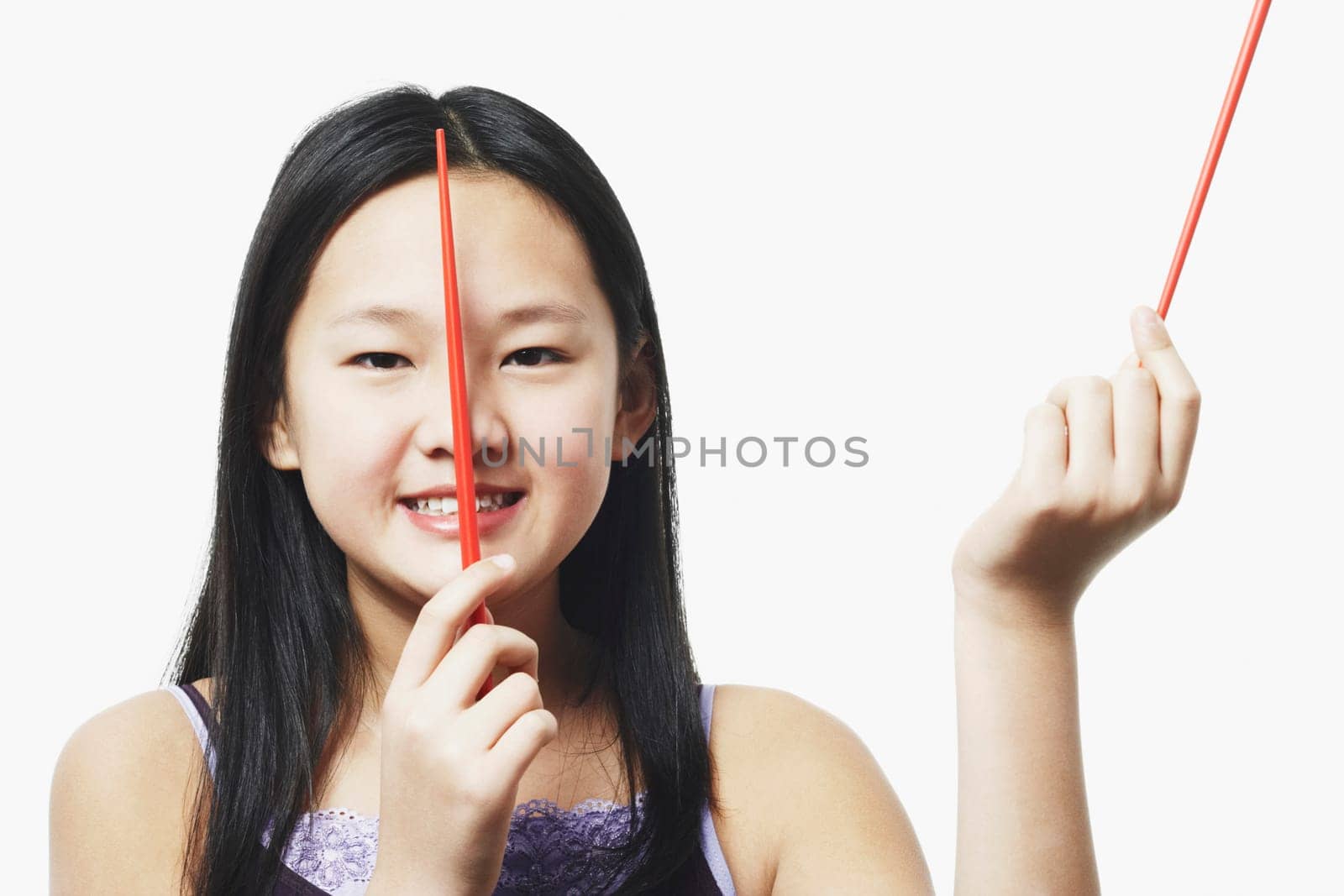 Portrait of a teenage girl holding chopsticks