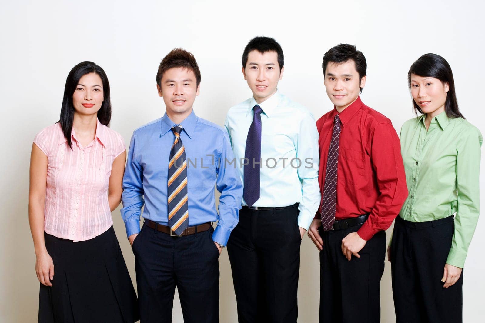 Portrait of five business executives standing and smiling together