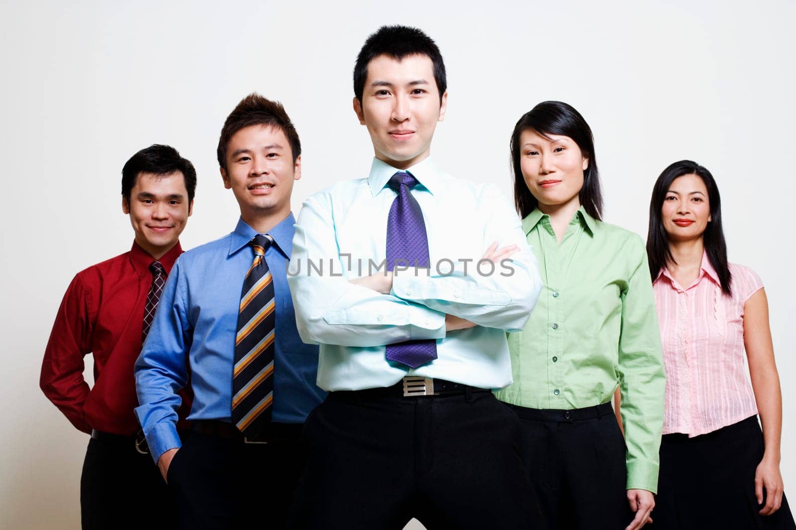Portrait of five business executives standing together and smiling