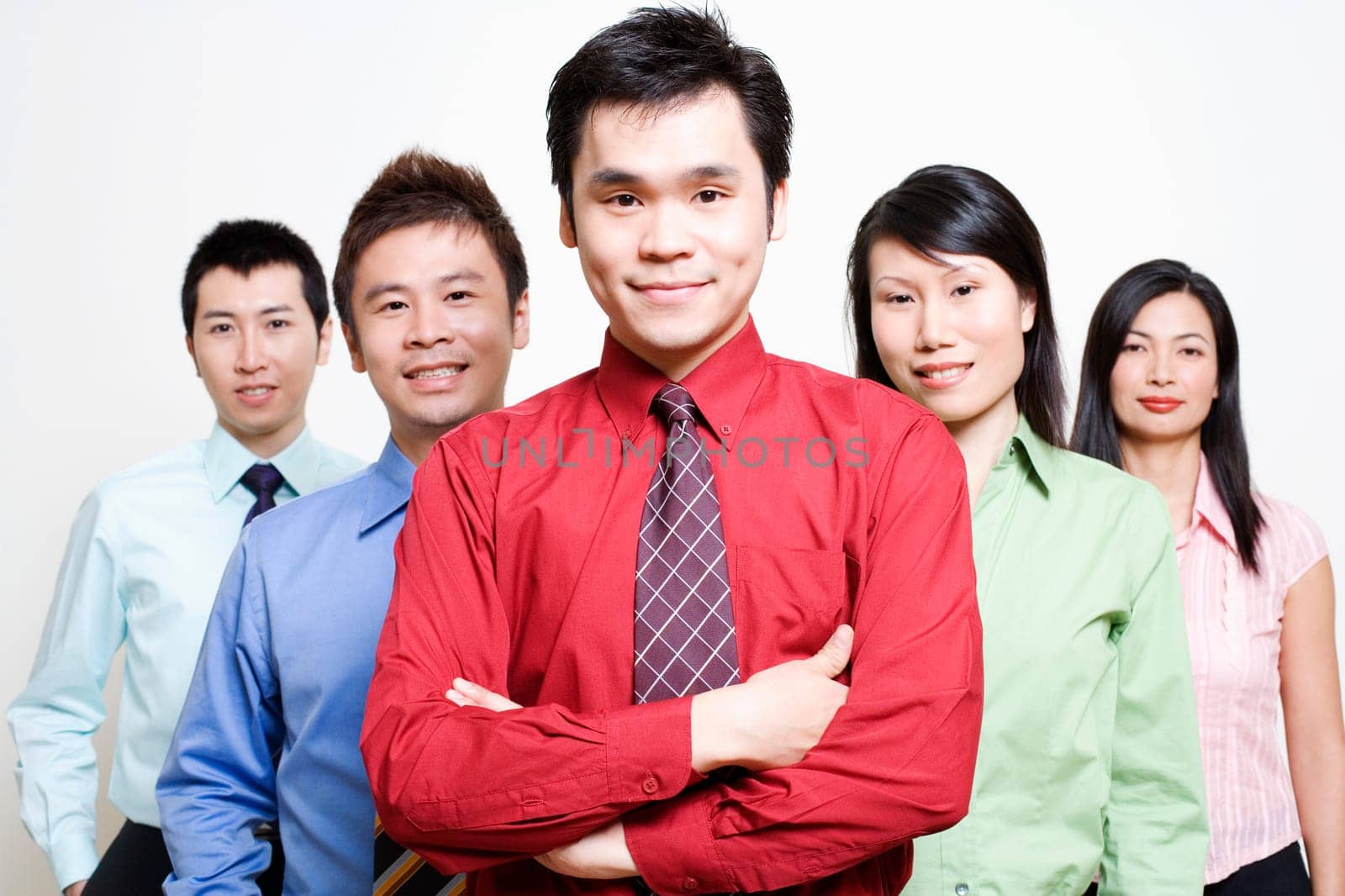 Portrait of five business executives standing together and smiling