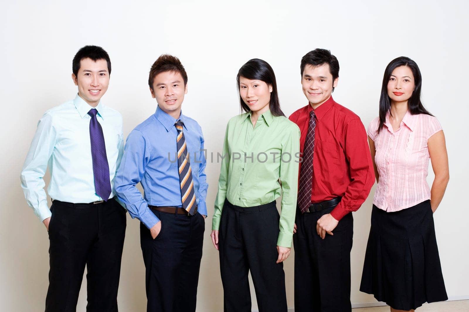 Portrait of five business executives standing together and smiling