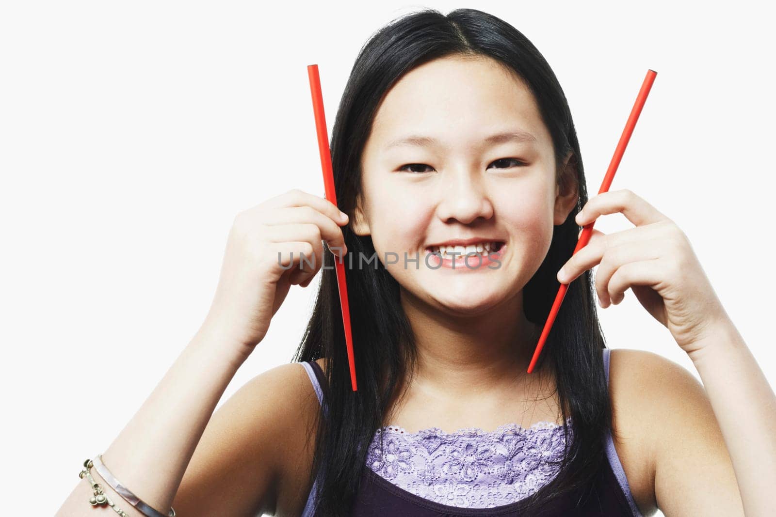 Portrait of a teenage girl holding chopsticks