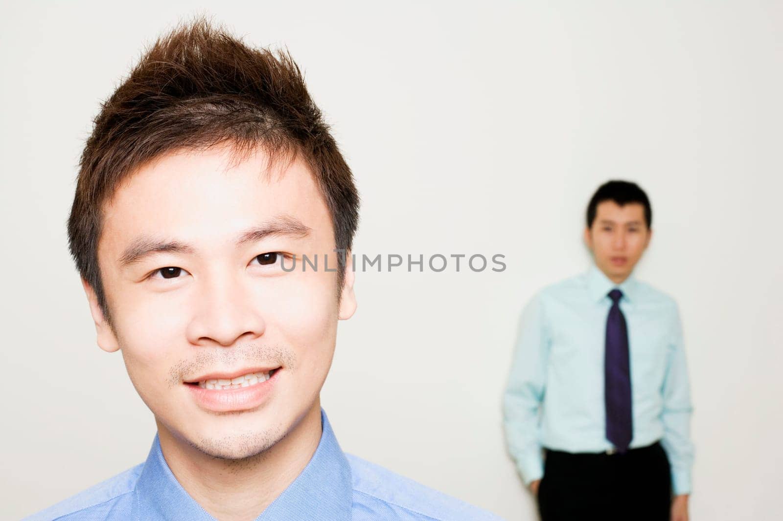 Portrait of a businessman with another standing behind him