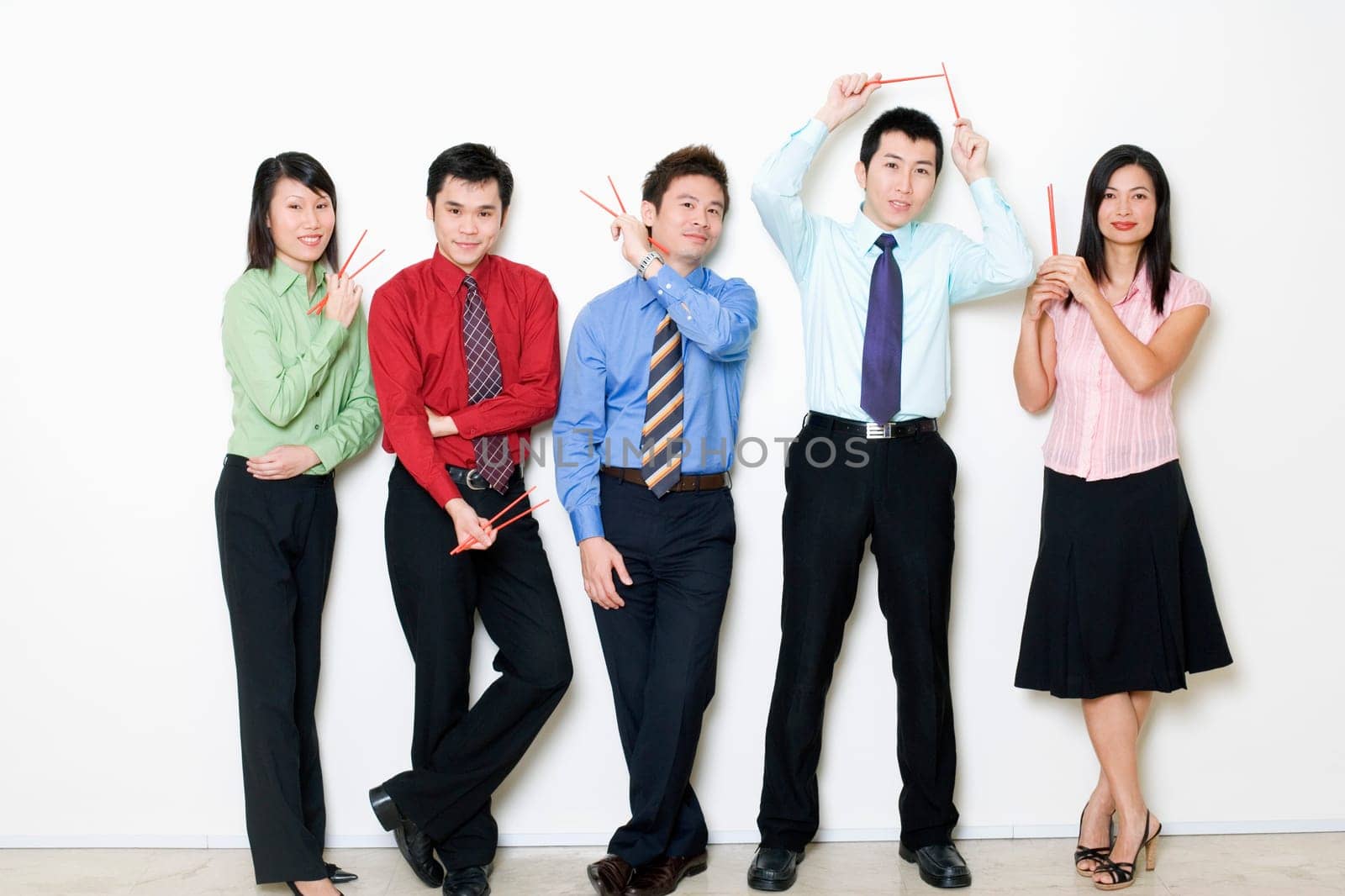 Portrait of five business executives holding chopsticks