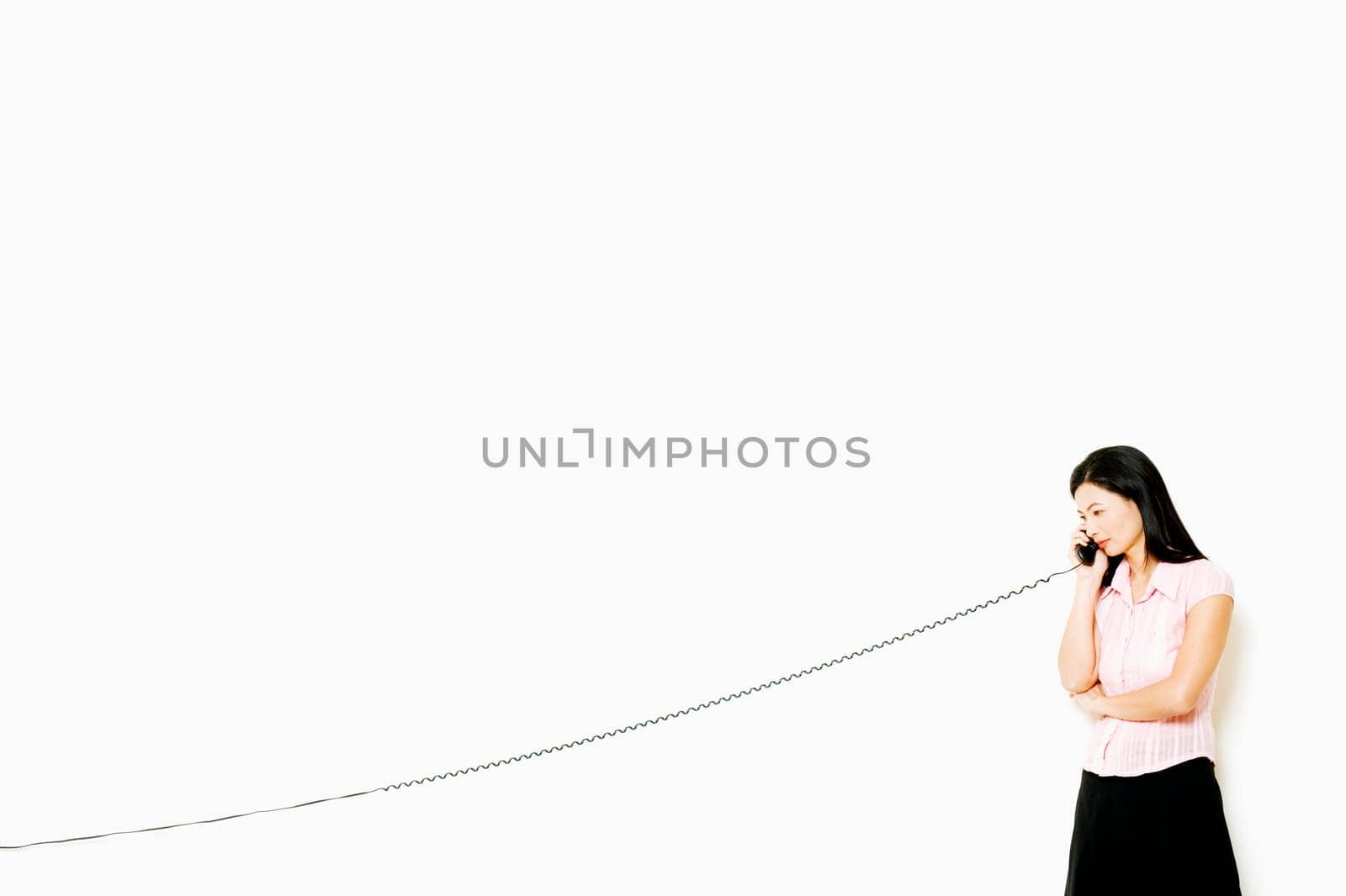 Mid adult woman talking on the telephone