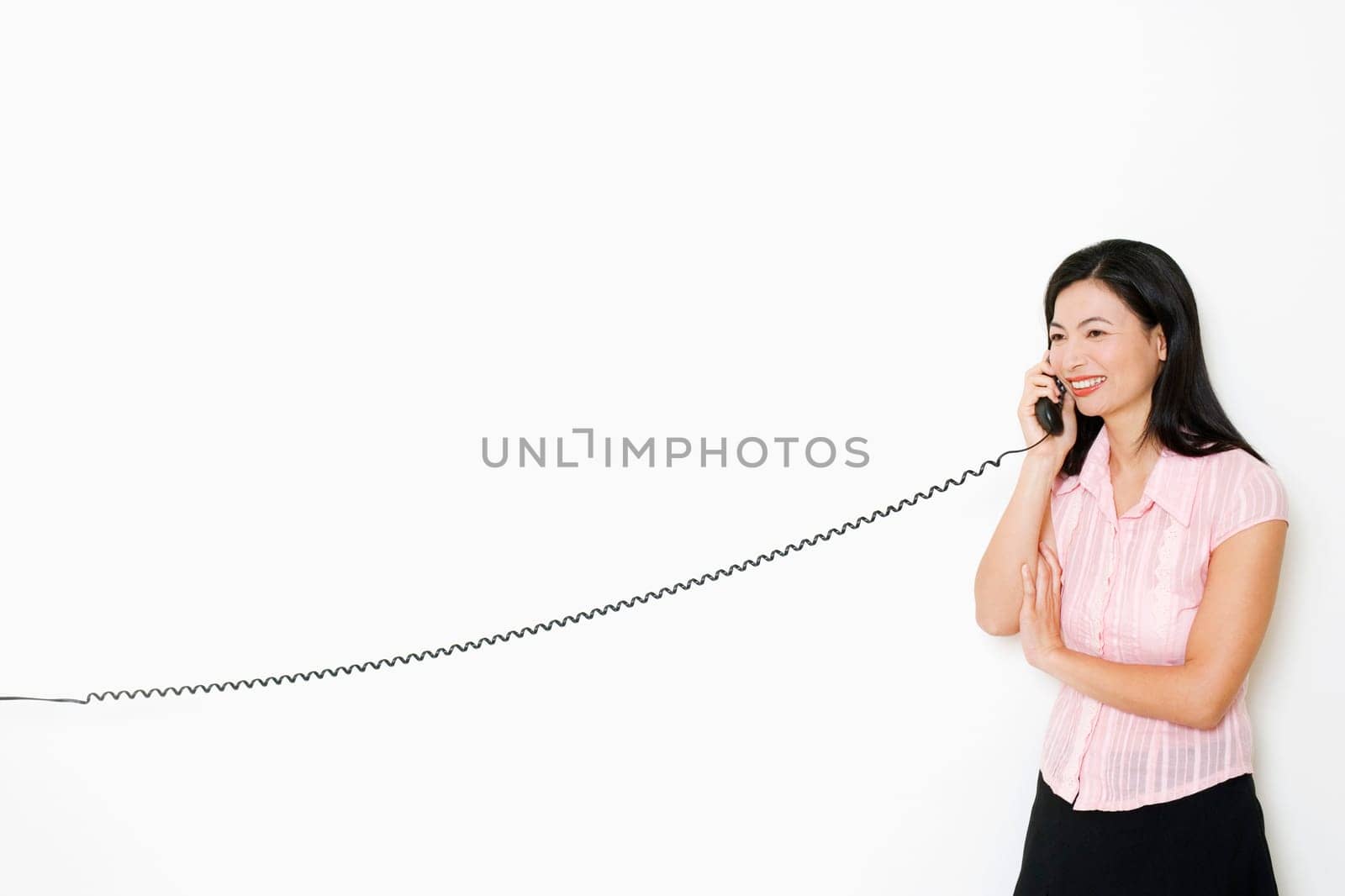 Mid adult woman talking on the telephone