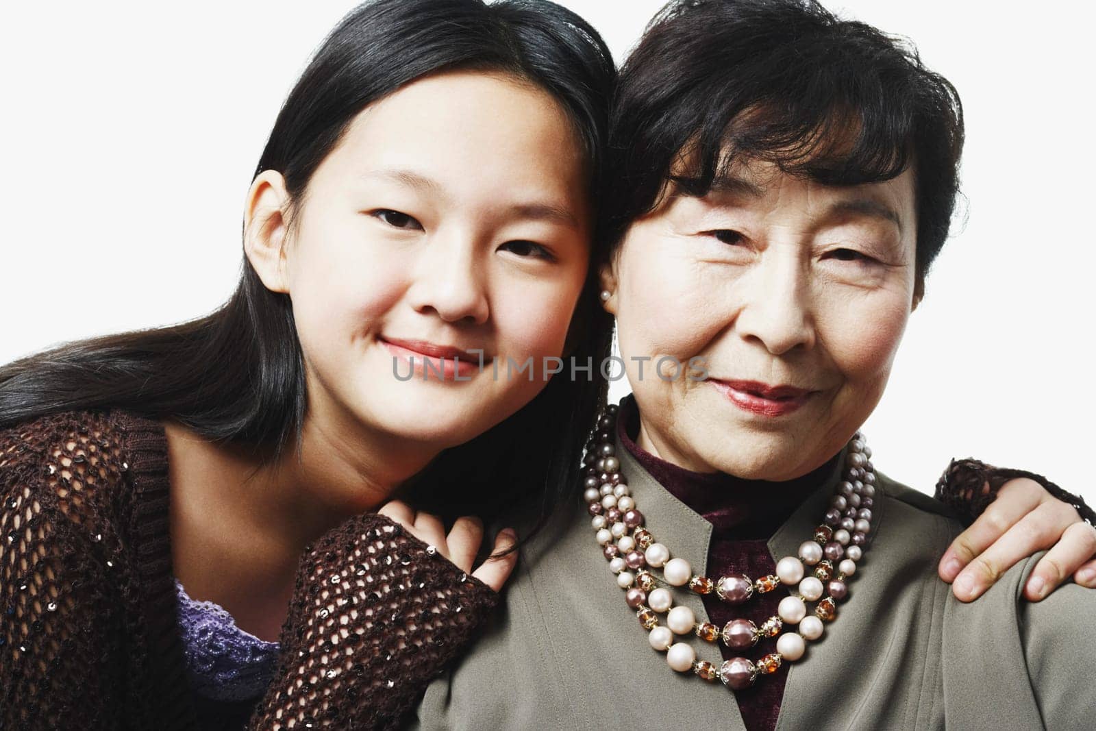 Portrait of a grandmother and her granddaughter smiling