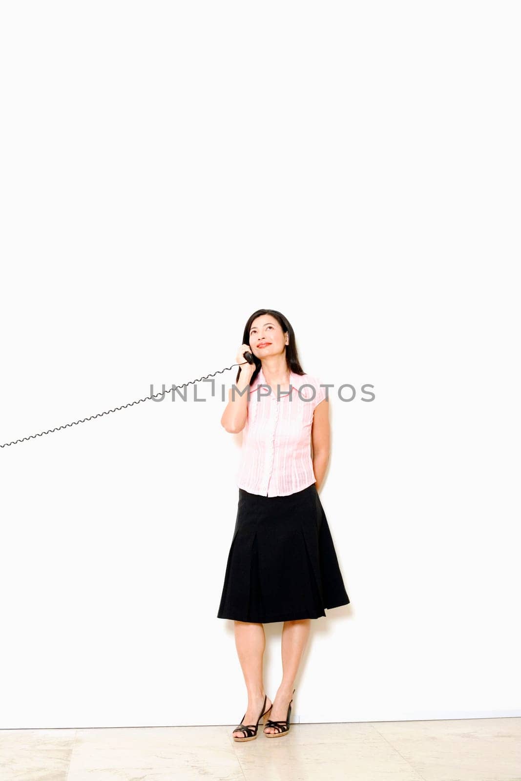 Mid adult woman talking on the telephone