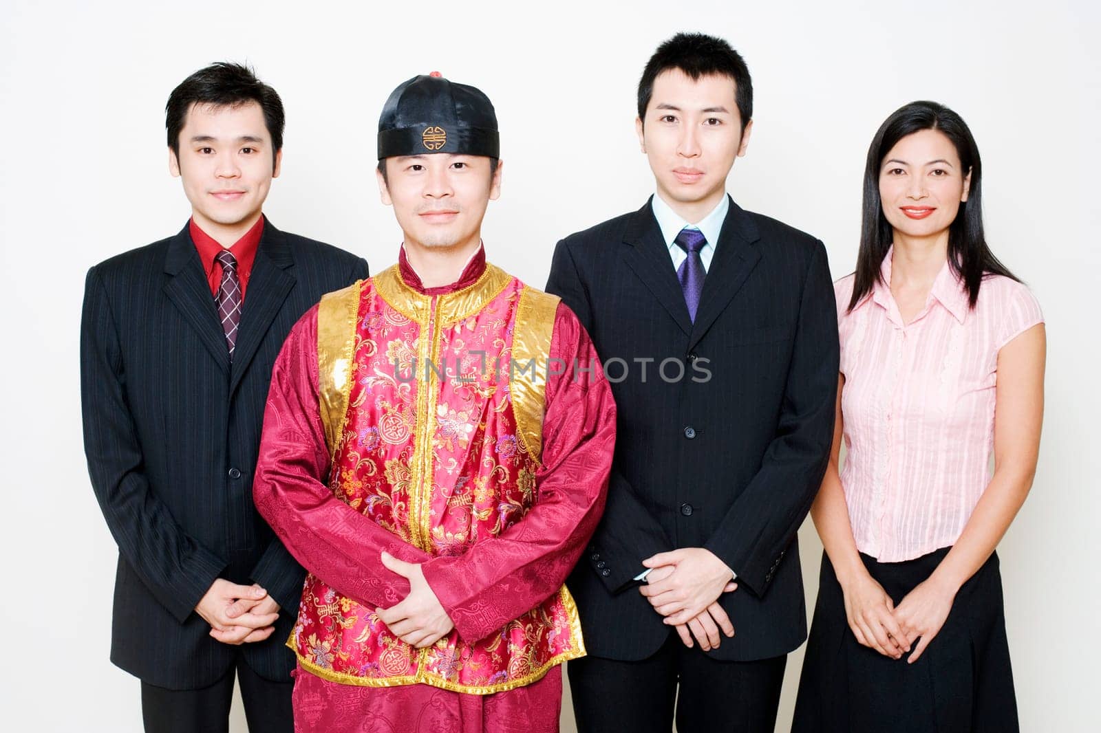 Portrait of three business executives and a young man standing together