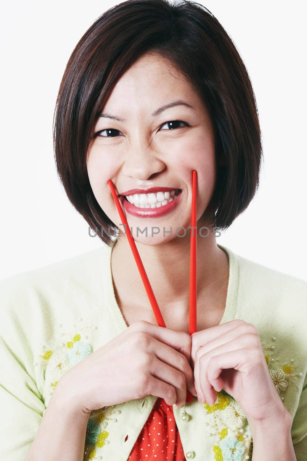 Portrait of a young woman holding chopsticks