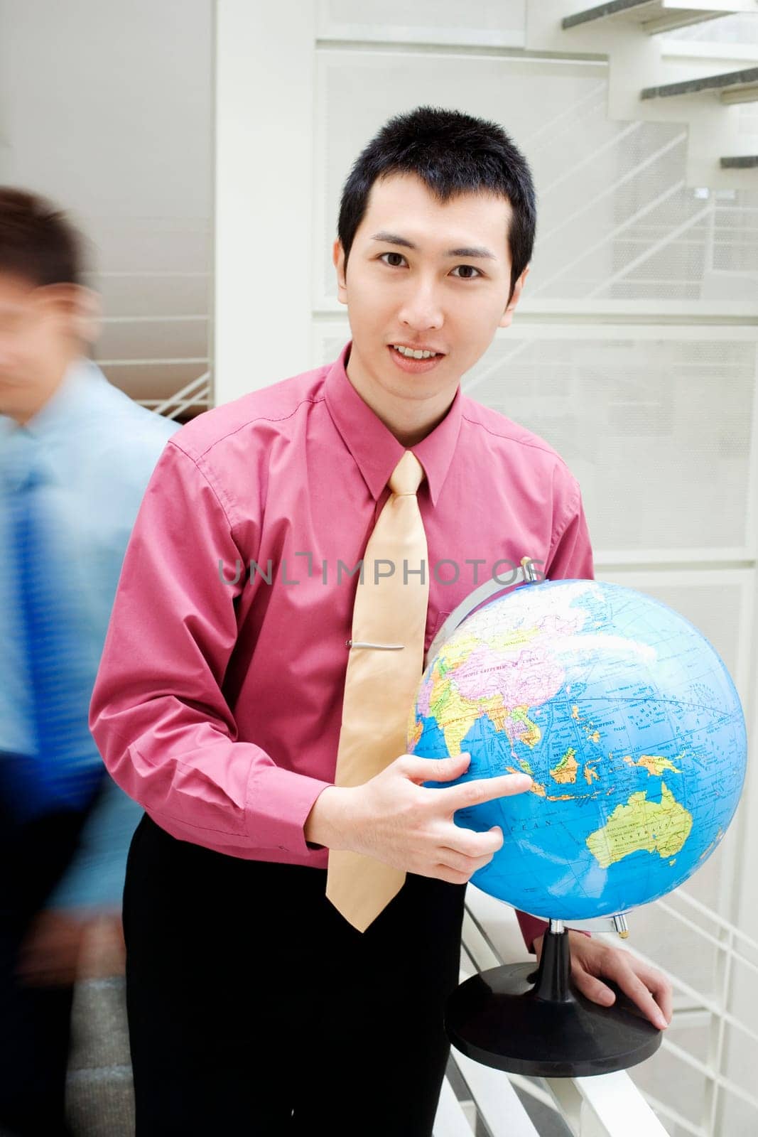 Portrait of a businessman holding a globe