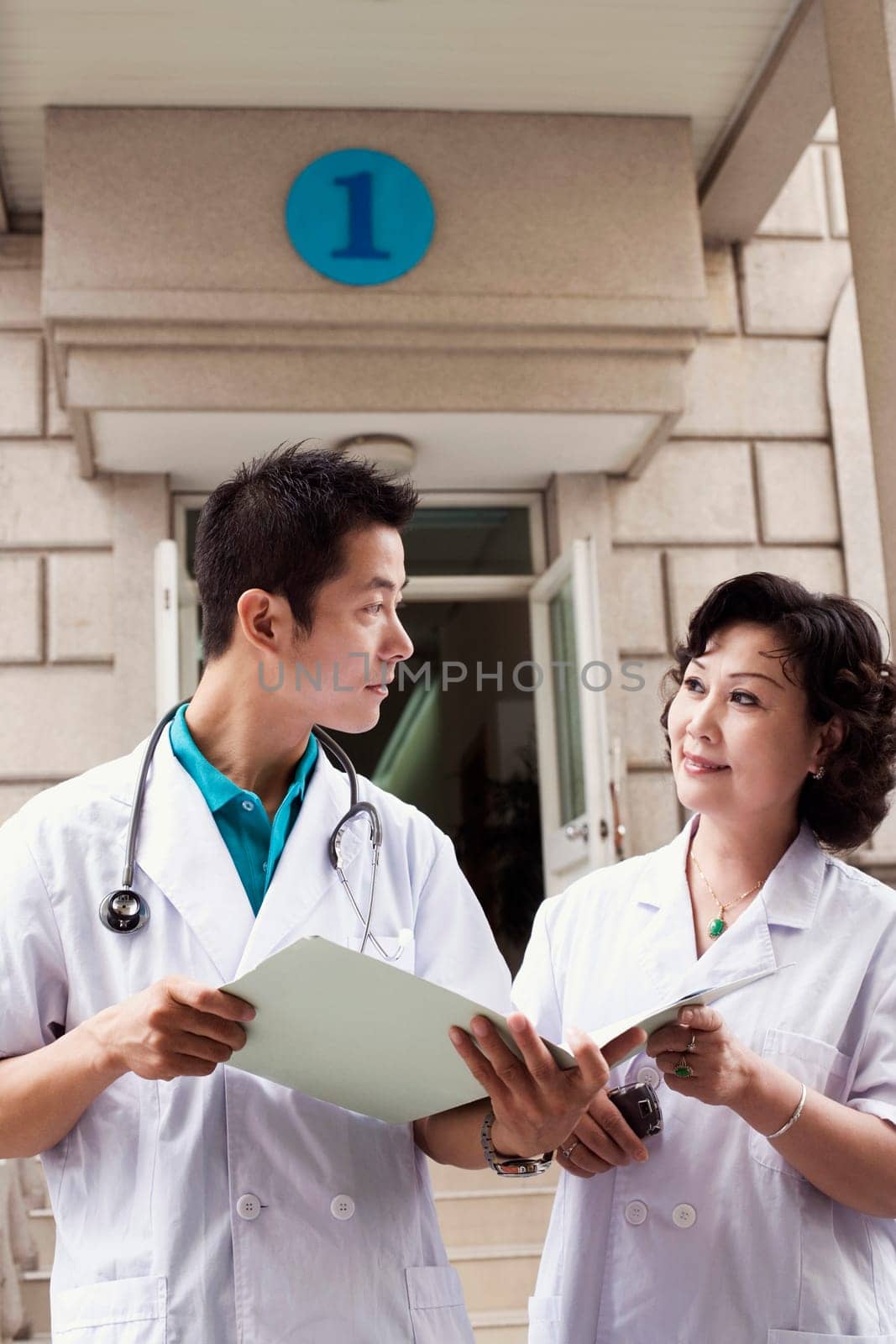 Male doctor and a female doctor discussing a report