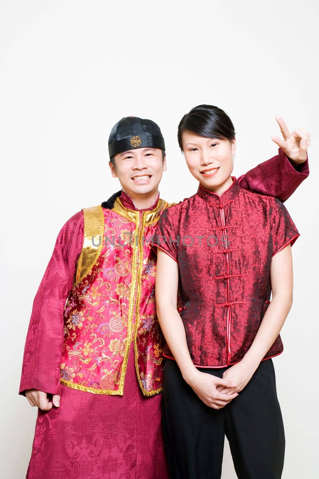 Young woman smiling with a young man making a peace sign