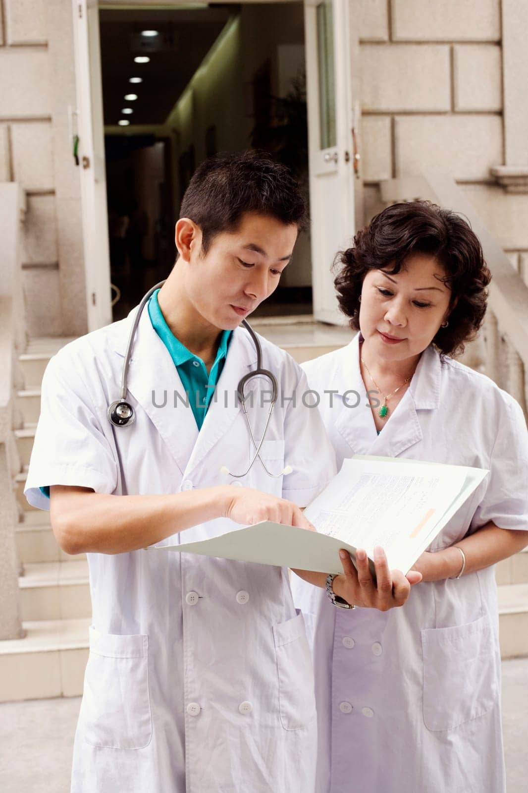 Male doctor and a female doctor discussing a report