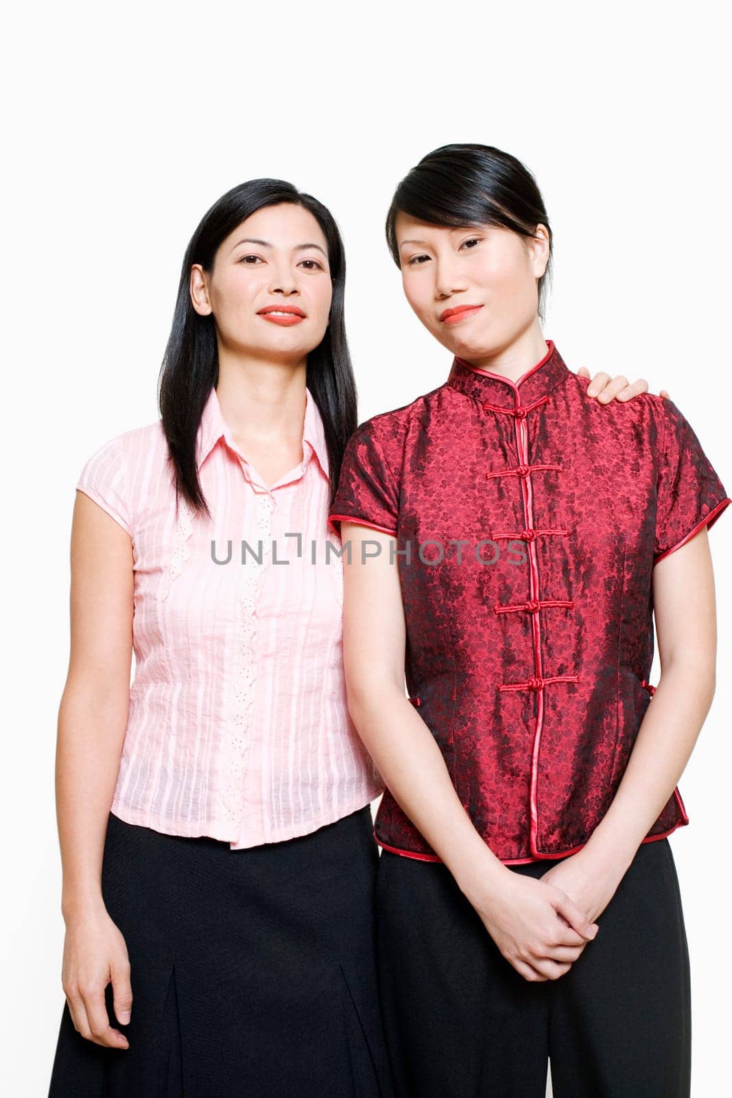 Portrait of a mid adult woman and young woman standing side by side