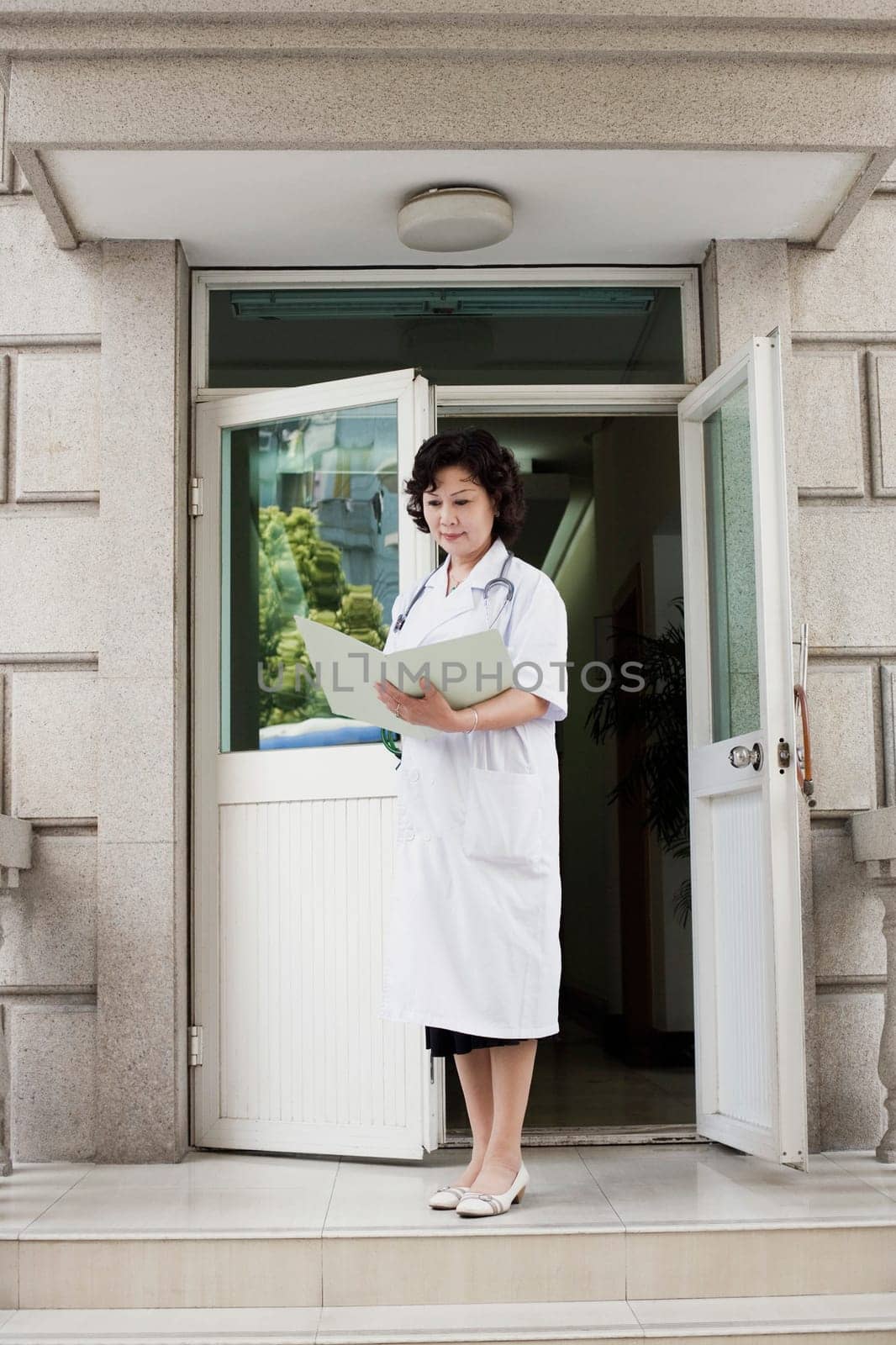 Female doctor reading a report