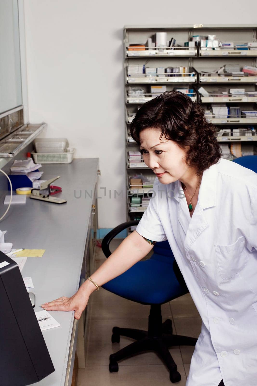 Close-up of a female pharmacist in a store room