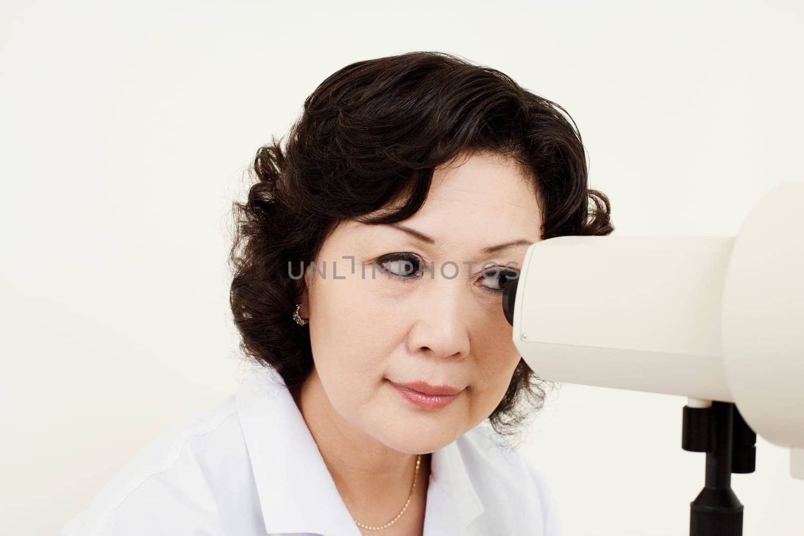 Close-up of an optometrist looking into an ophthalmoscope