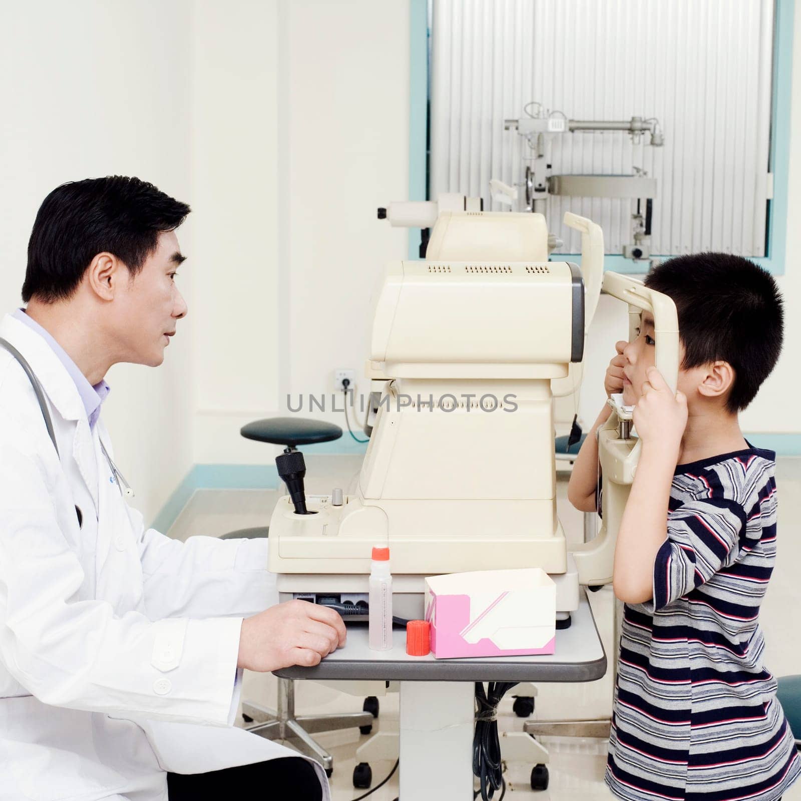 Side profile of an optometrist examining a patient