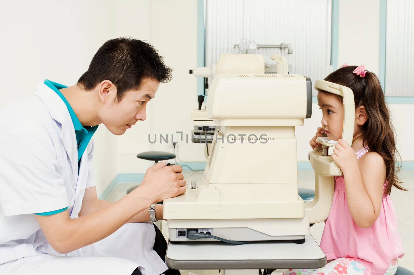 Side profile of an optometrist examining a patient