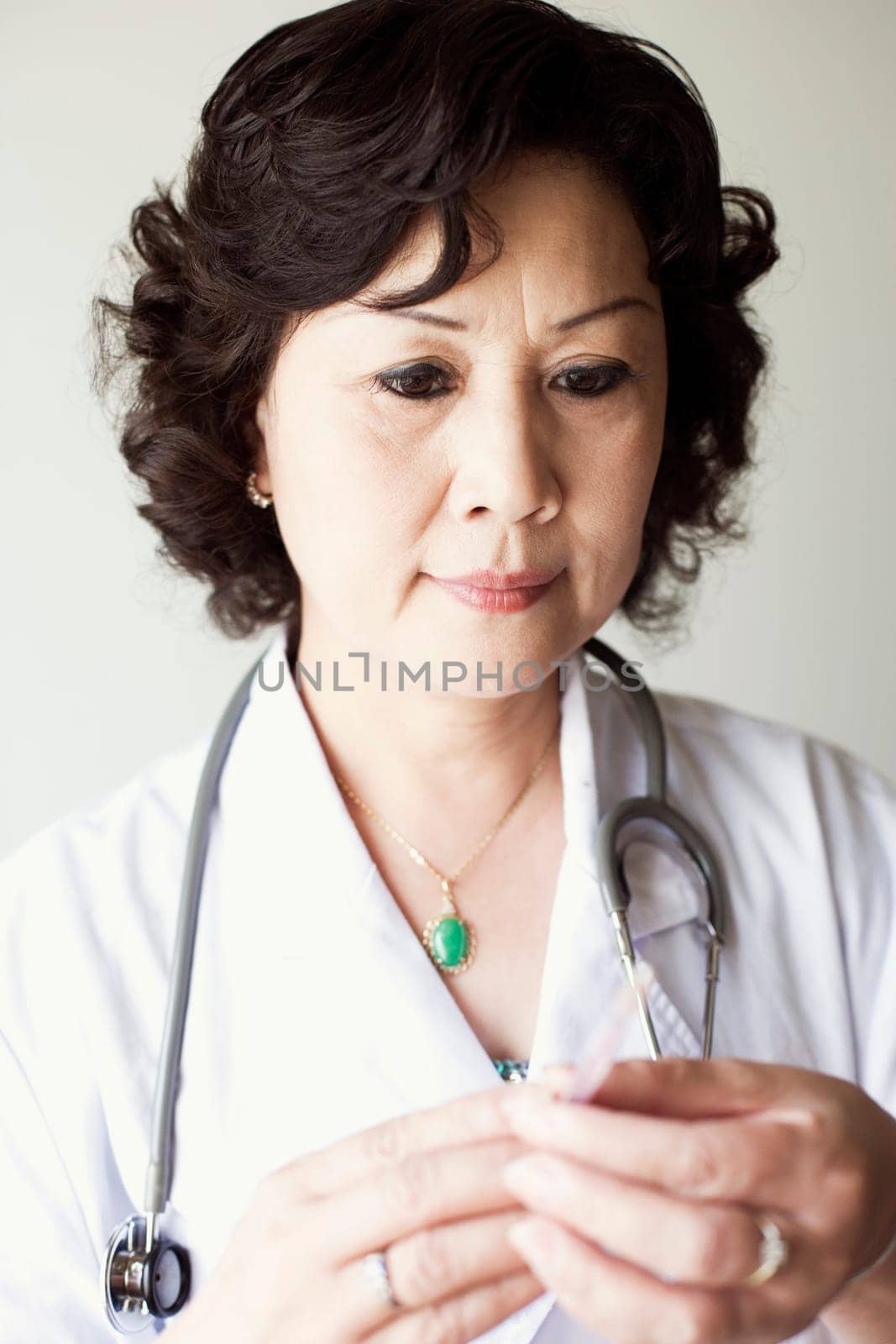 Close-up of a female doctor holding a syringe