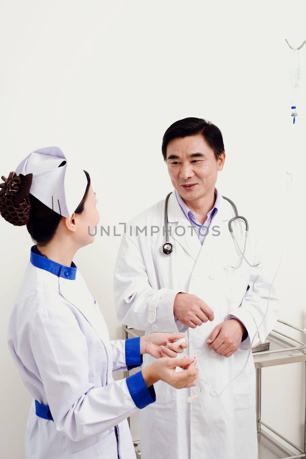 Male doctor talking to a female nurse