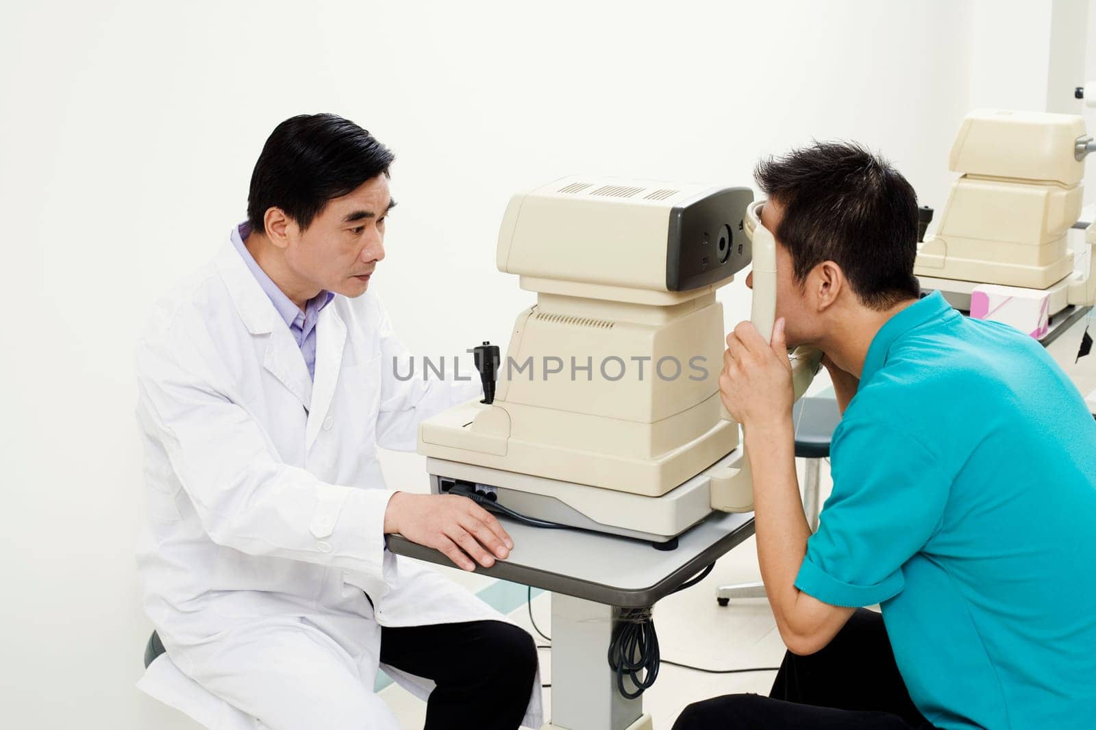 Side profile of an optometrist examining a patient