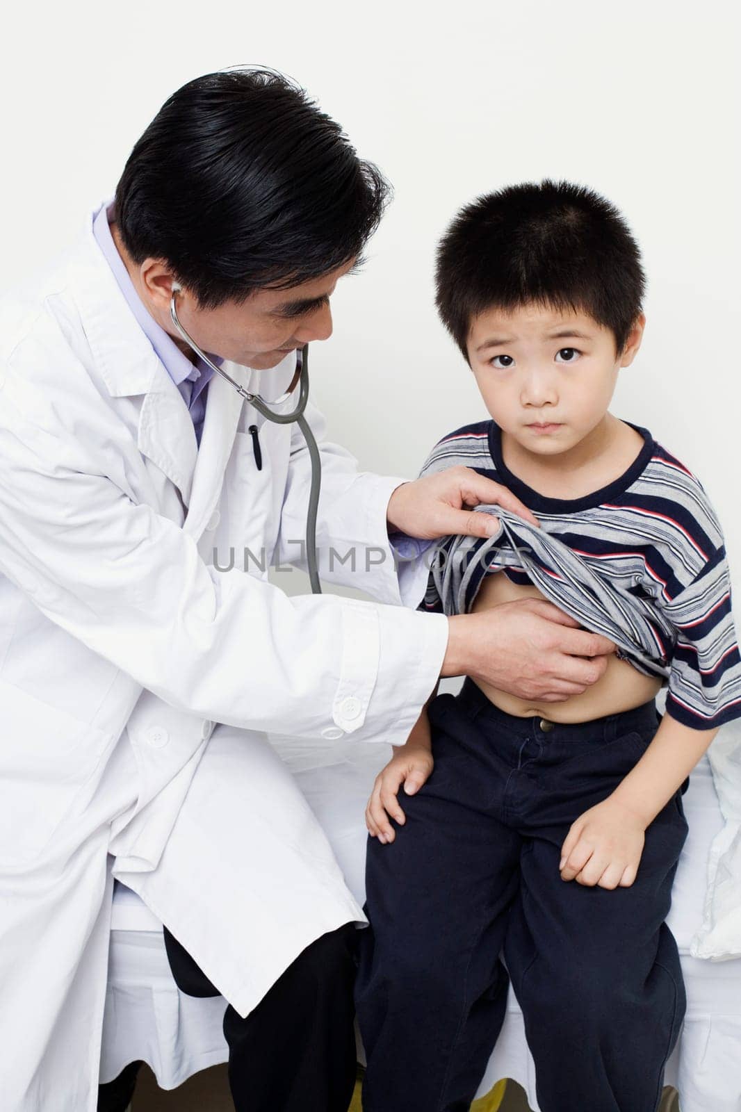 Close-up of a male doctor examining a child