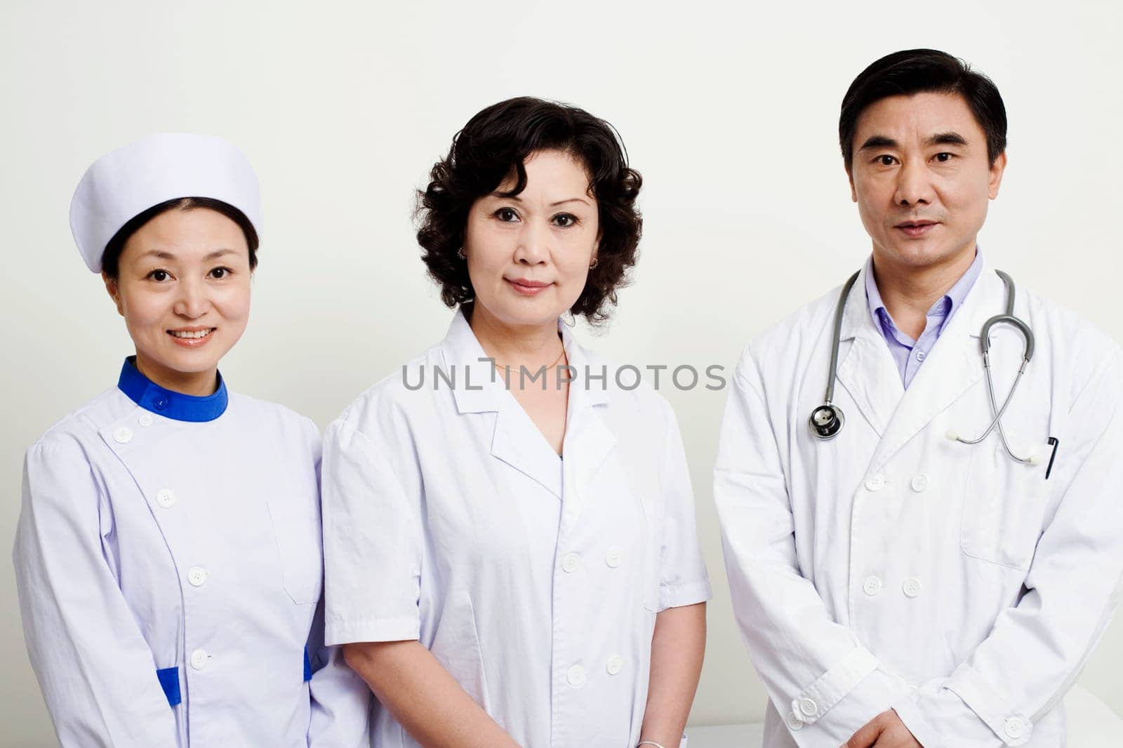 Portrait of a male doctor and a female doctor with a female nurse