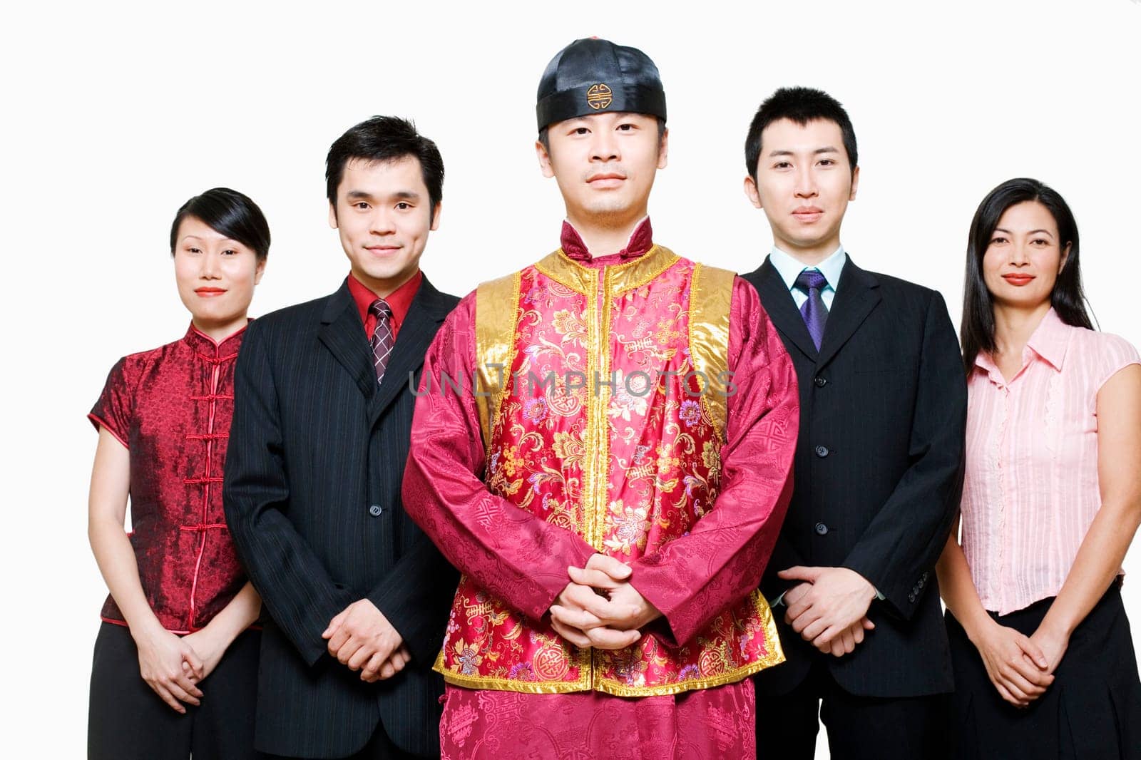 Portrait of four business executives and a young man standing together