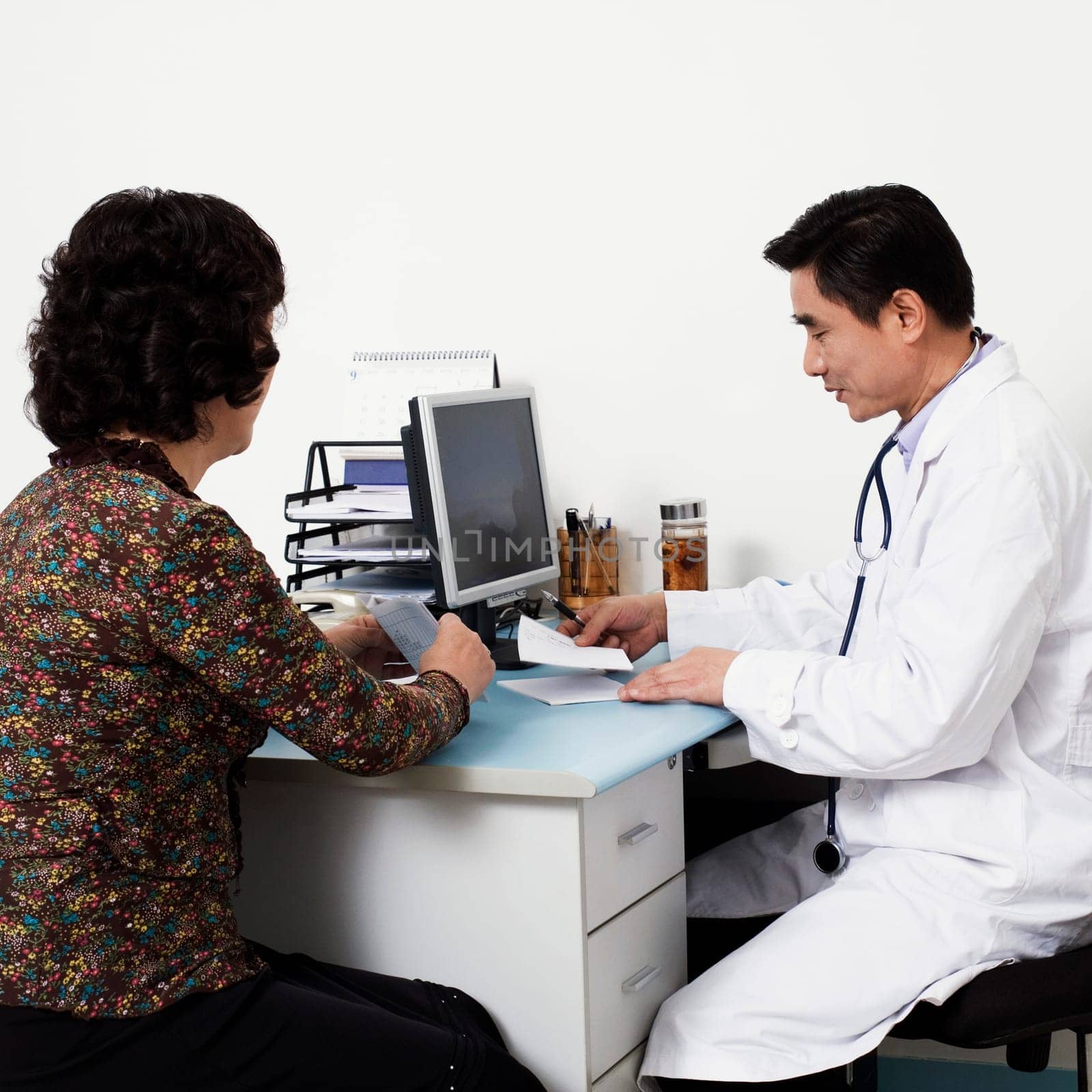 Close-up of a male doctor with a patient in his office