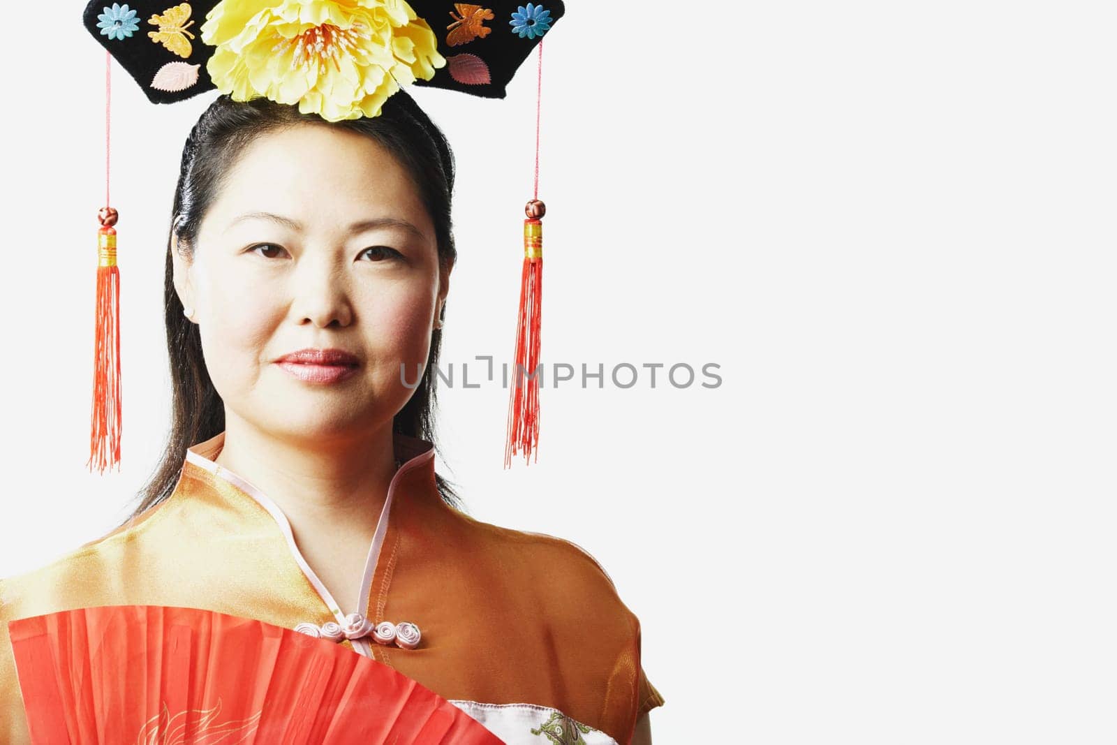 Portrait of a mid adult woman holding a folding fan